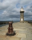 Pier of port of Whitby with lightouse