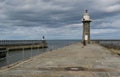 Pier of port of Whitby with lightouse