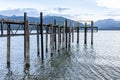 Pier projecting into lake Te Anau with mountain range background.in scenic New Zealand image.