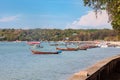 Pier Rawai beach in thailand on the island of phuket with old fishing wooden boats with long ropes moored to the shore Royalty Free Stock Photo