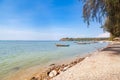 Pier Rawai beach in thailand on the island of phuket with old fishing wooden boats with long ropes moored to the shore Royalty Free Stock Photo