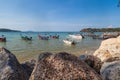 Pier Rawai beach in thailand on the island of phuket with old fishing wooden boats with long ropes moored to the shore Royalty Free Stock Photo