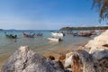 Pier Rawai beach in thailand on the island of phuket with old fishing wooden boats with long ropes moored to the shore Royalty Free Stock Photo