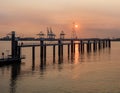 Pier in river Scheldt with container terminal at sunset, Port of Antwerp, Belgium Royalty Free Stock Photo