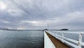 Pier in the sea in Auckland. It`s a cloudy day overlooking Auckland City in New Zealand. Royalty Free Stock Photo