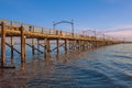 Pier on the sea at sunset. View of a wooden bridge Twilight. Colorful sunset over the White Rock Pier British Columbia Royalty Free Stock Photo