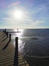 Pier shadows and lights of the pier, waves in the sea. Royalty Free Stock Photo