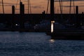 Pier Sign Lit Up on a Sunset on a Marina with Boats Royalty Free Stock Photo