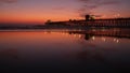 Pier silhouette Oceanside California USA. Ocean tide tropical beach. Summertime gloaming atmosphere.