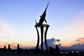 Pier silhouette of swordfish statue at sunset