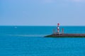 Pier with small lighthouse and blue ocean, scenery of the harbor of Breskens, Zeeland, The Netherlands