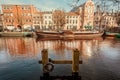 Pier for small river boats at dutch city channel with moored boats for transportation