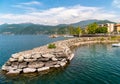 Pier of the small tourist town Luino on the shore of Lake Maggiore in province of Varese, Italy Royalty Free Stock Photo