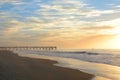 The pier at sunrise on Atlantic ocean. Royalty Free Stock Photo