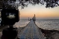 The pier and sunrise on the sea. Camera mounted on a tripod at foreground defocused Royalty Free Stock Photo