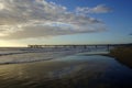 Pier in the sunset with reflections on the shore Royalty Free Stock Photo