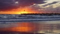 Pier in the sunset with reflections on the shore Royalty Free Stock Photo