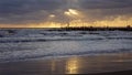 Pier in the sunset with reflections on the shore Royalty Free Stock Photo