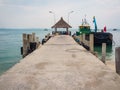 Pier with a thatched roof and a boat in Thailand