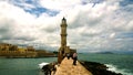 Pier to the lighthouse in city of Chania on island of Crete in cloudy windy weather