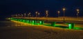 pier to the sea at night in full lighting Royalty Free Stock Photo