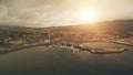 Pier town citycsape with historic buildings at ocean bay aerial. Sun ships, yachts at marina wharf