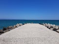 Pier of the town of Pomorie / Bulgaria, covered with breakwaters around, which protects the beach and the city from strong waves. Royalty Free Stock Photo