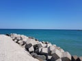 Pier of the town of Pomorie / Bulgaria, covered with breakwaters around, which protects the beach and the city from strong waves. Royalty Free Stock Photo