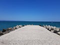 Pier of the town of Pomorie / Bulgaria, covered with breakwaters around, which protects the beach and the city from strong waves. Royalty Free Stock Photo