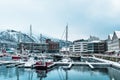 Pier and traditional and new modern buildings in marina of Tromso, Norway, Scandic hotel in the background Royalty Free Stock Photo