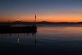 A pier at Trasimeno lake Umbria, Italy at dusk, with beautiful water reflections and warm colors Royalty Free Stock Photo