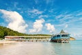 Pier in turquoise water on blue sky background. Sea beach with wooden shelter on sunny day in antigua. Summer vacation Royalty Free Stock Photo