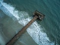 Pier at Tybee Island in Georgia surrounded by Atlantic Ocean waves as seen from drone Royalty Free Stock Photo