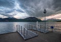 Pier in Weggis Village on Lucerne lake under dramatic clouds, Switzerland