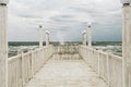 Pier with white wooden handrails at sea during a storm. Royalty Free Stock Photo