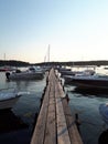 Pierce in perspective to fisherman boats in the sea in the evening in Rab Croatia