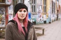 pierced and inked young woman in front of run-down graffiti covered houses Royalty Free Stock Photo