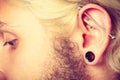 Pierced man ear, black plug tunnel, industrial and rook Royalty Free Stock Photo