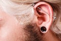 Pierced man ear, black plug tunnel, industrial and rook Royalty Free Stock Photo