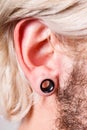 Pierced man ear, black plug tunnel Royalty Free Stock Photo