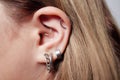 piercings on an ear. Conch and helix piercings close up.