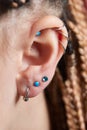 piercings on an ear. Conch and helix piercings close up. Royalty Free Stock Photo