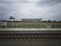 Pierzchno,Poland - May 20, 2023: view of the glass passenger shed on the platform placed by the field, railroad platform