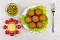 Pies stuffed with meat on lettuce, mayonnaise, tomato, green pea Royalty Free Stock Photo