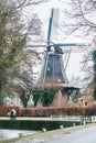 Pieterburen, Netherlands - January 10, 2020. Old windmill in the middle of the village in winter Royalty Free Stock Photo