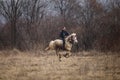 Man is bareback riding an adorned horse before an Epiphany celebration horse race