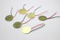 Piezoelectric discs with wires soldered made of copper on a white background Royalty Free Stock Photo
