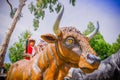 PIFO, ECUADOR - NOVEMBER, 13, 2017: Beautiful stoned sculpture of a orange bull in a park of Pifo, Ecuador