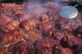 Pig knuckles, traditional Ukrainian delicatessen. meat is cooked at festivals in a large frying pan on fire Royalty Free Stock Photo