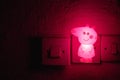 Pig Night Light. Small pink light for night . Cute Peppa pig lighting in the room. Plug in night light Royalty Free Stock Photo